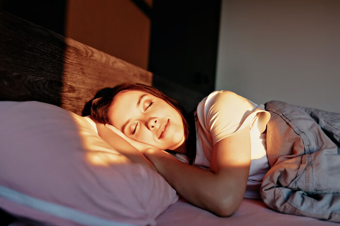 A peaceful worker sleeps in a sunny bed, wishing corporate buzzwords would disappear.