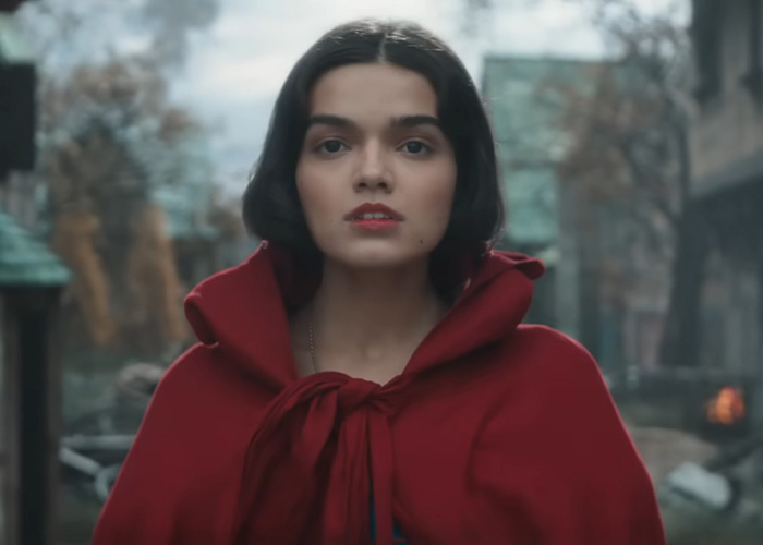 Rachel Zegler looking directly at the camera. She's wearing a red cape, related to the Odyssey movie's woke question.