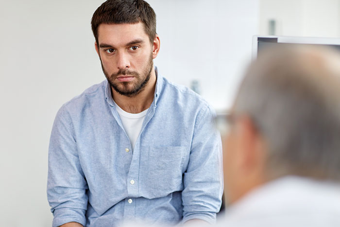 A man looking concerned about paperwork naming him as baby's dad after an ex ends relationship. A man looking concerned about paperwork naming him as baby's dad after an ex ends relationship.