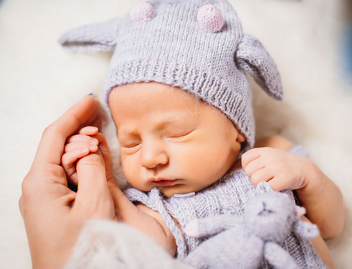 A newborn baby, possibly related to official paperwork naming a man as baby's dad. A newborn baby, possibly related to official paperwork naming a man as baby's dad.