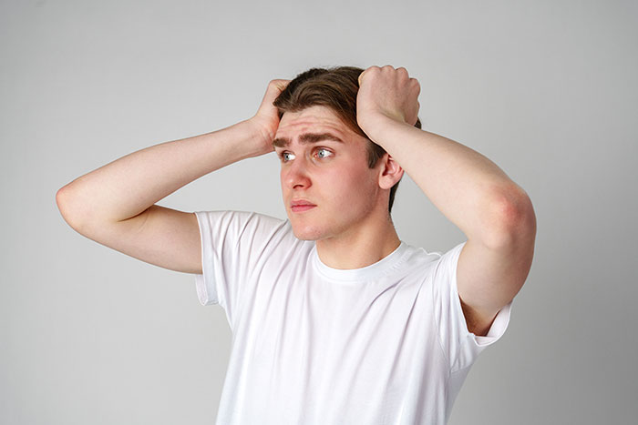 A man with hands on head, looking distressed, dealing with the shock of an ex naming him baby’s dad via paperwork. A man with hands on head, looking distressed, dealing with the shock of an ex naming him baby’s dad via paperwork.