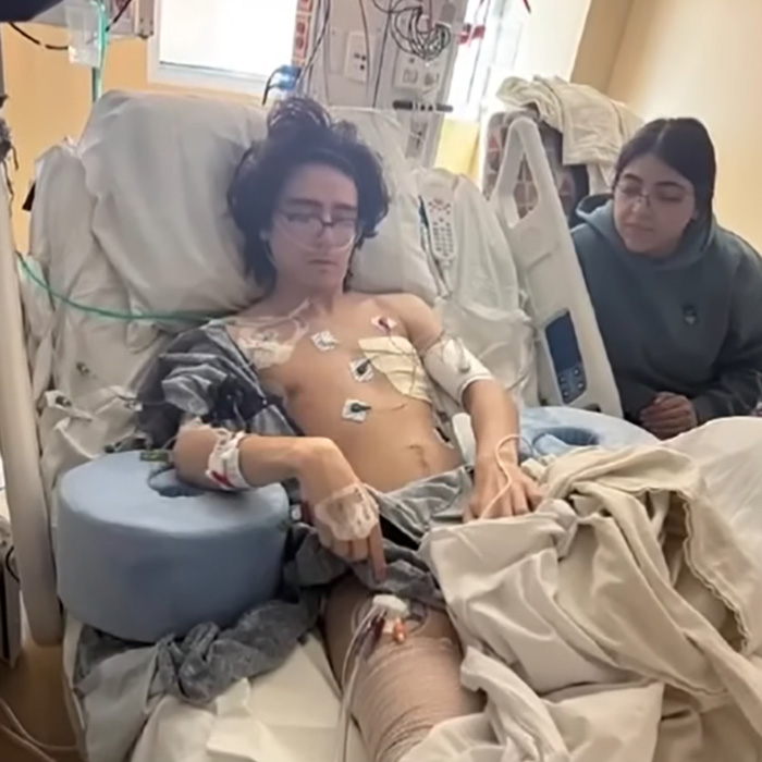 A man paralyzed in a doxxing and swatting prank lies in a hospital bed with medical tubes and wires. A man paralyzed in a doxxing and swatting prank lies in a hospital bed with medical tubes and wires.