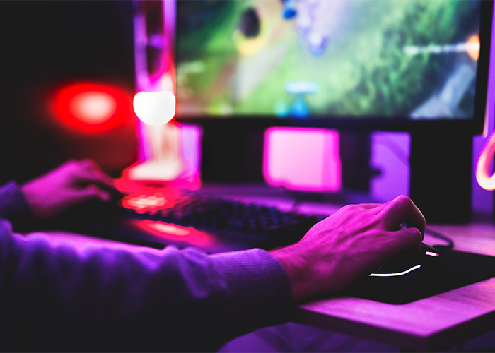 A gamer's hands at a keyboard and mouse, symbolizing online activities that led to a doxxing, swatting prank. A gamer's hands at a keyboard and mouse, symbolizing online activities that led to a doxxing, swatting prank.