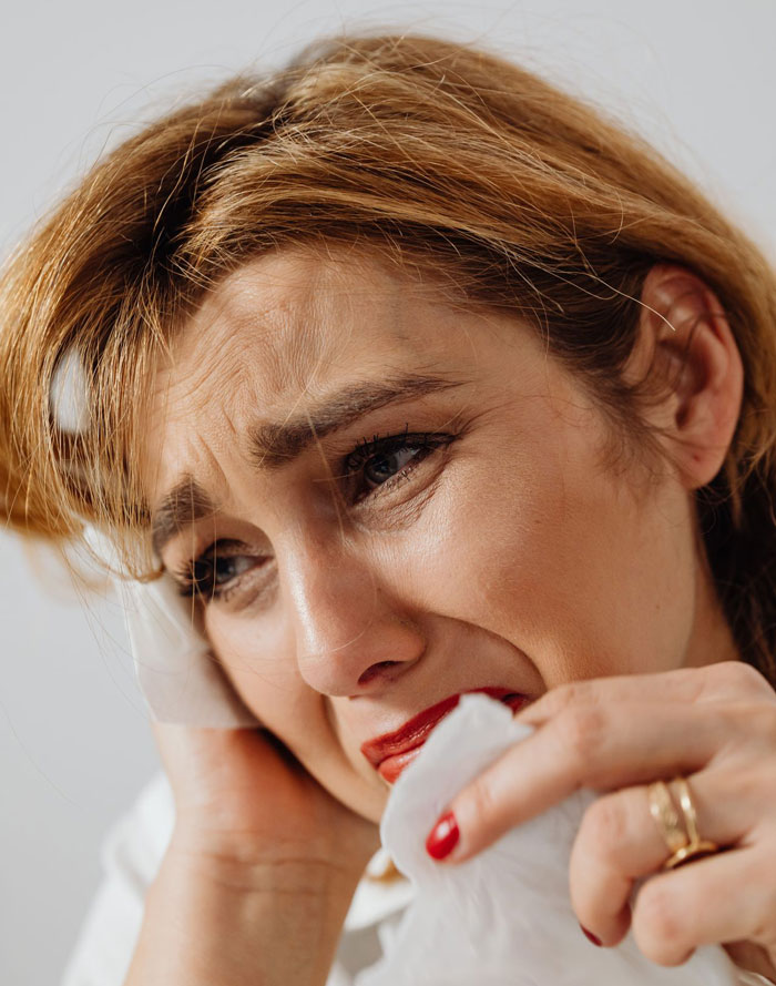 A woman crying, symbolizing the sad news a husband plans to spring to his wife. A woman crying, symbolizing the sad news a husband plans to spring to his wife.