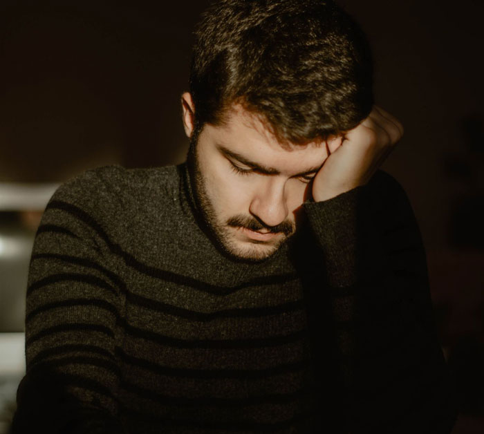 A pensive man, representing a husband, grappling with sad news he needs to share with his wife. A pensive man, representing a husband, grappling with sad news he needs to share with his wife.