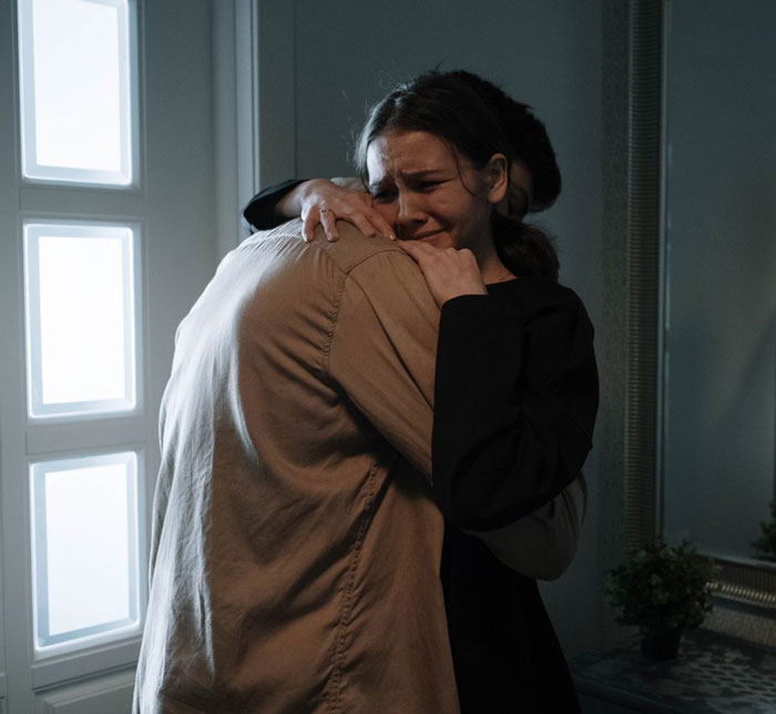 Husband plans to spring huge and sad news to wife after a trip of a lifetime. A woman cries while being hugged by a man. Husband plans to spring huge and sad news to wife after a trip of a lifetime. A woman cries while being hugged by a man.