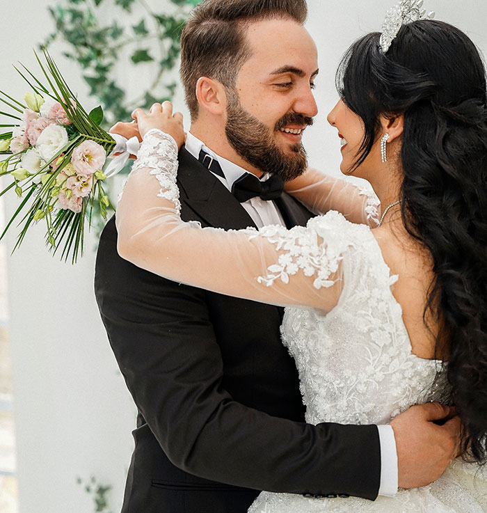 Happy bride and groom at a wedding, celebrating their special day, unaware of an entitled man's plans.