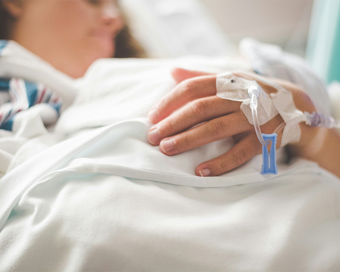 A close-up of a patient's hand with an IV, symbolizing the struggle after the famous model was left fighting for life. A close-up of a patient's hand with an IV, symbolizing the struggle after the famous model was left fighting for life.