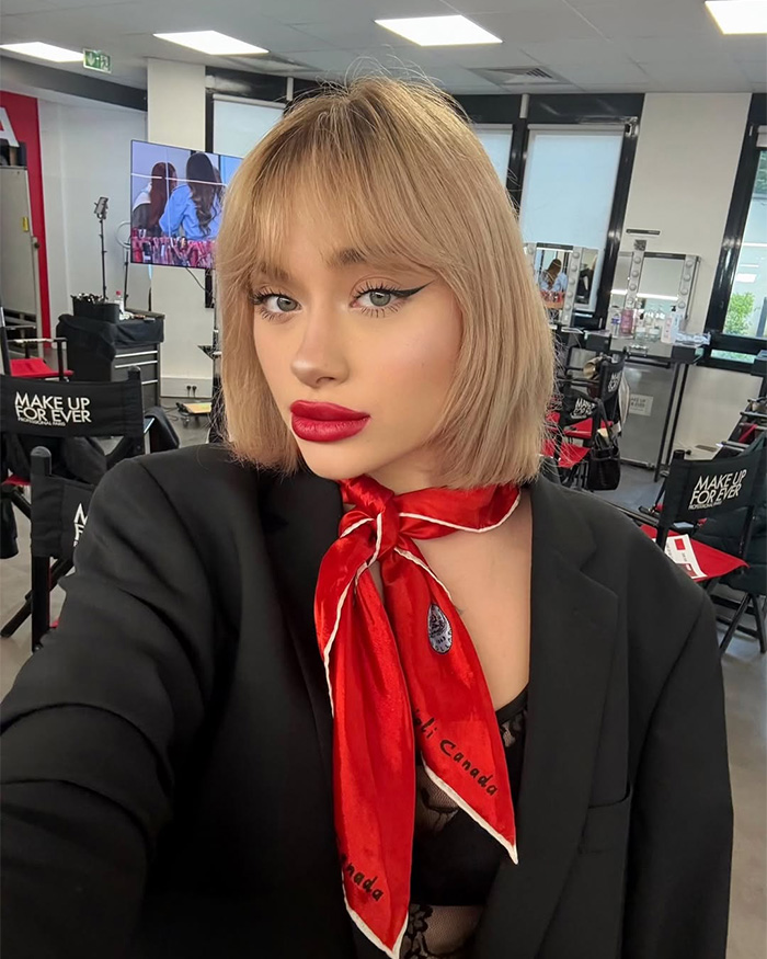 A young woman with a red scarf and bold makeup, who dreamed of becoming a famous model. A young woman with a red scarf and bold makeup, who dreamed of becoming a famous model.