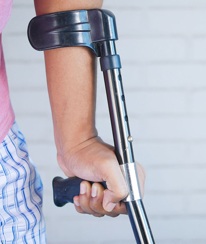 A person's arm using a crutch, symbolizing a potential difficult path or wedding red flags.