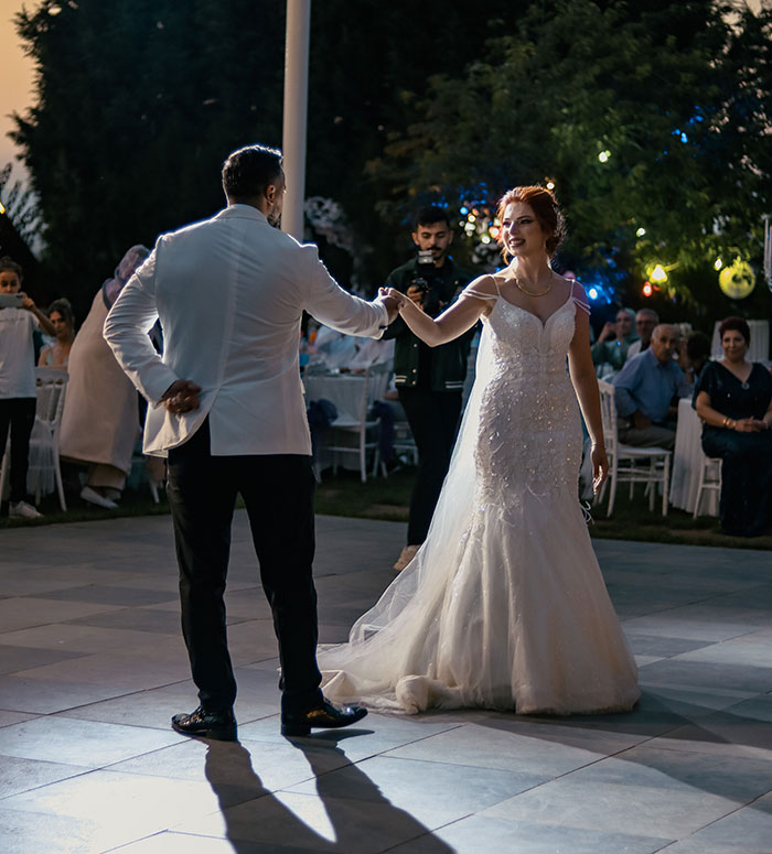 A newlywed couple dancing at their wedding reception, unaware of possible wedding red flags.