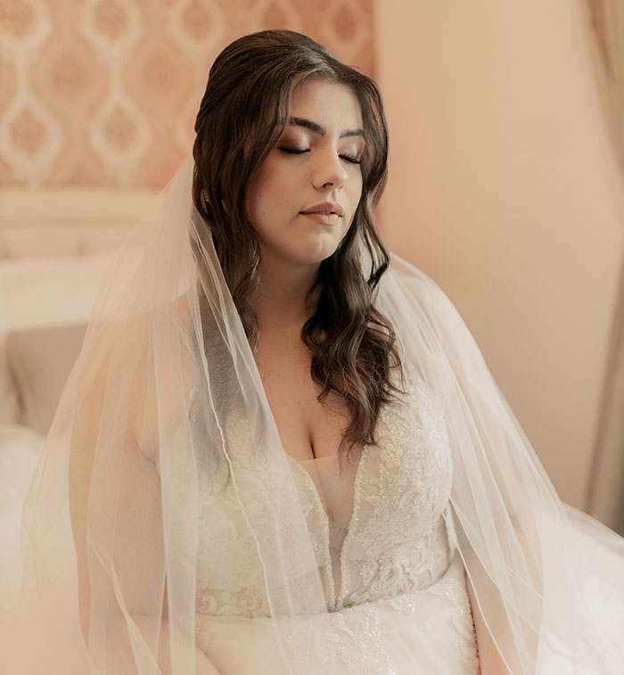 A pensive bride with closed eyes, perhaps reflecting on wedding red flags or the upcoming marriage.