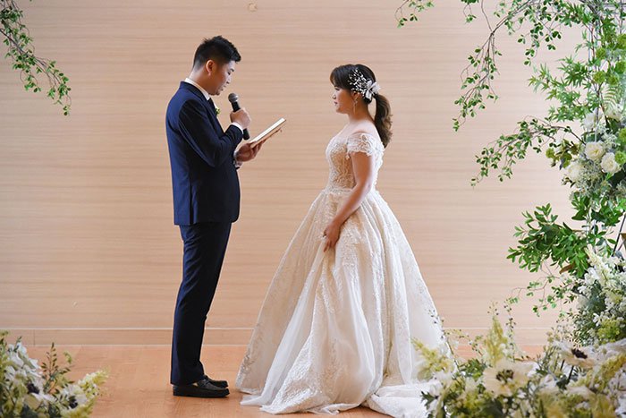 A bride and groom exchanging vows during their wedding ceremony, showing signs of wedding red flags.
