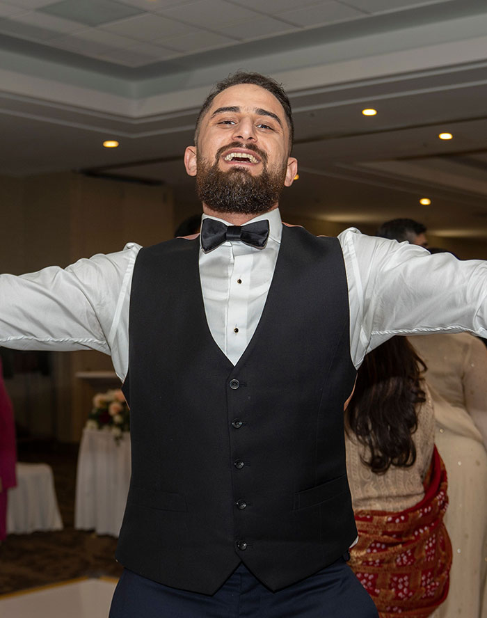A happy wedding guest dancing at a wedding, celebrating with friends and family. This could be a wedding red flag.