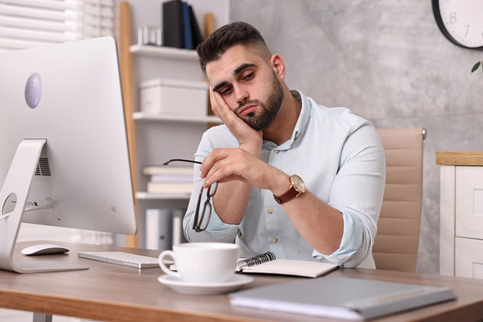 An ex-Meta worker looking tired at his desk, contemplating how AI is replacing his team and taking his job. An ex-Meta worker looking tired at his desk, contemplating how AI is replacing his team and taking his job.