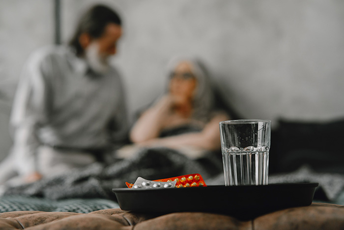 A tray with a glass of water and pills, symbolizing a woman's suspicion about her future mother-in-law. A tray with a glass of water and pills, symbolizing a woman's suspicion about her future mother-in-law.