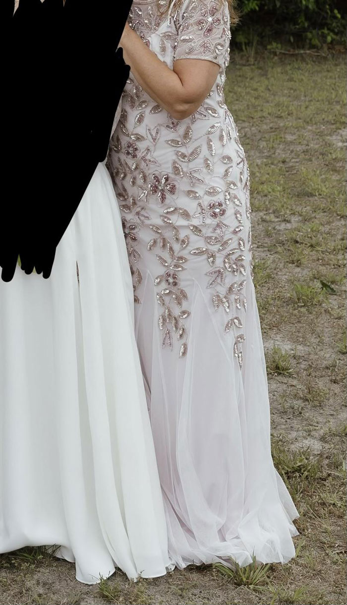 Mother-in-law (MIL) in a white dress next to a bride on her wedding day. Mother-in-law (MIL) in a white dress next to a bride on her wedding day.