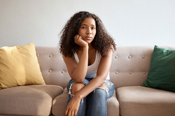 A frustrated bride on a couch, dealing with her toxic in-law family A frustrated bride on a couch, dealing with her toxic in-law family