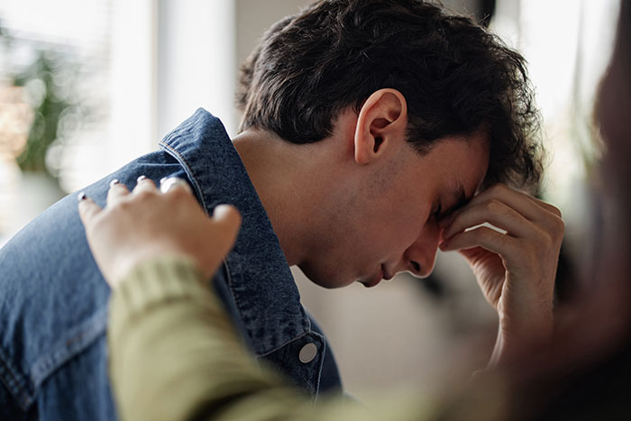 A teen boy is comforted by a hand on his shoulder as he struggles with the decision to donate his lung to his mom. A teen boy is comforted by a hand on his shoulder as he struggles with the decision to donate his lung to his mom.