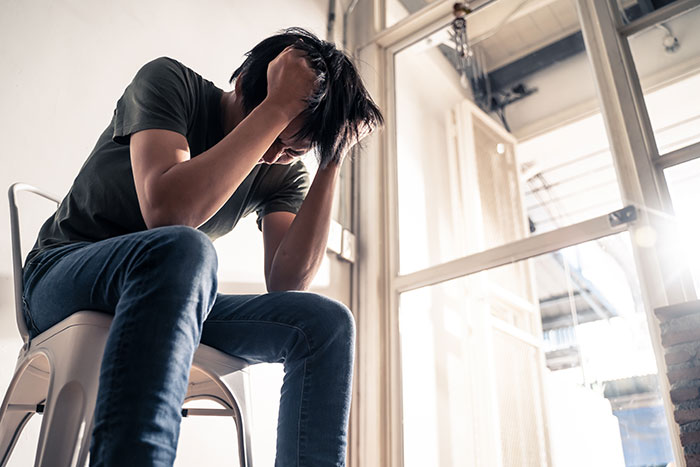 A teen looking distressed, holding his head, as he grapples with the decision to donate his lung to his mom. A teen looking distressed, holding his head, as he grapples with the decision to donate his lung to his mom.