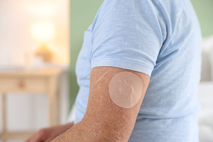 A person wears a nicotine patch on their arm, highlighting the mom's refusal to donate a lung to her son. A person wears a nicotine patch on their arm, highlighting the mom's refusal to donate a lung to her son.