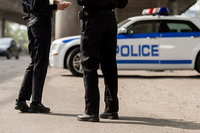 Two police officers stand next to a patrol car, representing the teen's life a mess after refusing to donate his lung. Two police officers stand next to a patrol car, representing the teen's life a mess after refusing to donate his lung.
