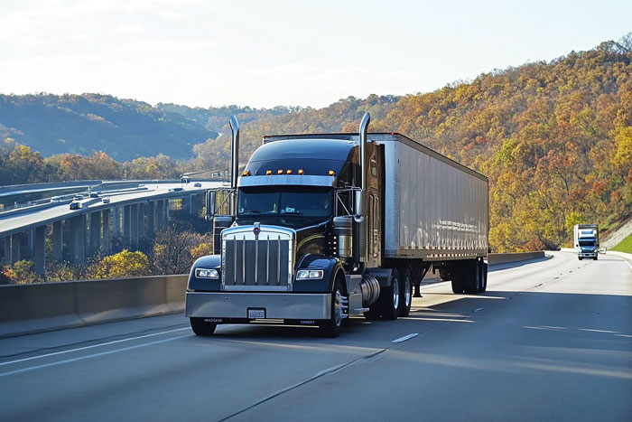 Large truck driving on a highway, illustrating one of the 5 things a mortician avoids.
