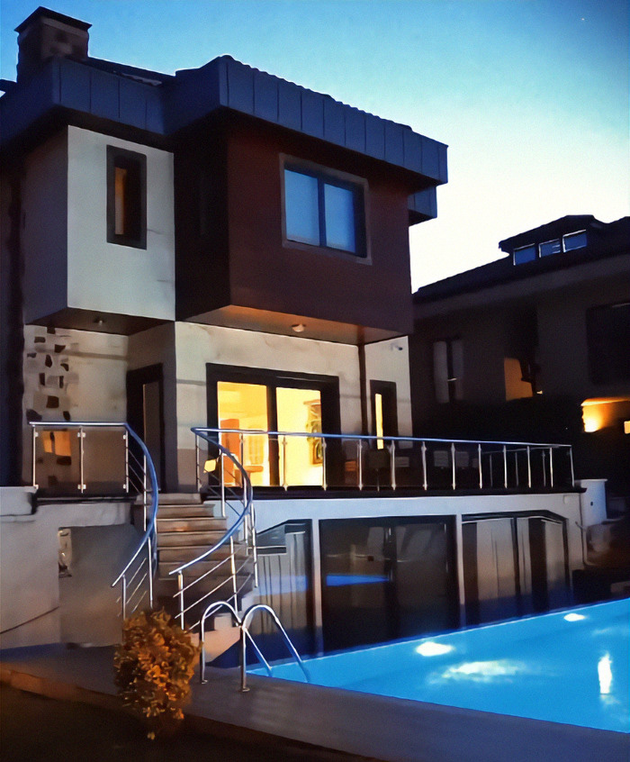 An exterior view of a modern house with a pool, likely the accommodation during a mother's barbaric surgery trip to Turkey. An exterior view of a modern house with a pool, likely the accommodation during a mother's barbaric surgery trip to Turkey.
