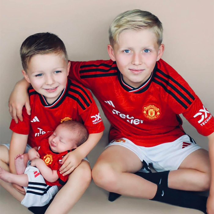 Three young brothers, including a newborn, emphasizing the devastating impact of a mother's passing due to botched surgery. Three young brothers, including a newborn, emphasizing the devastating impact of a mother's passing due to botched surgery.