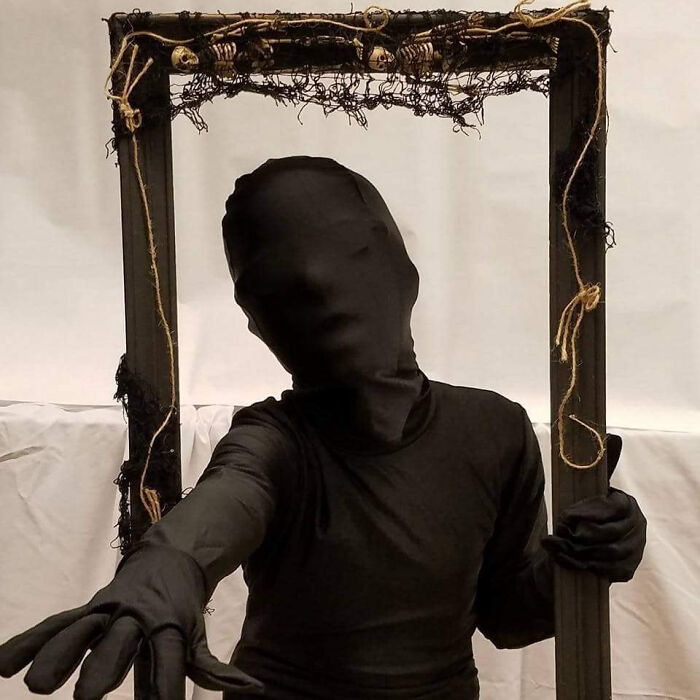 A person in a black full-body suit stands in a spooky frame, evoking how parents were terrified of their own children.
