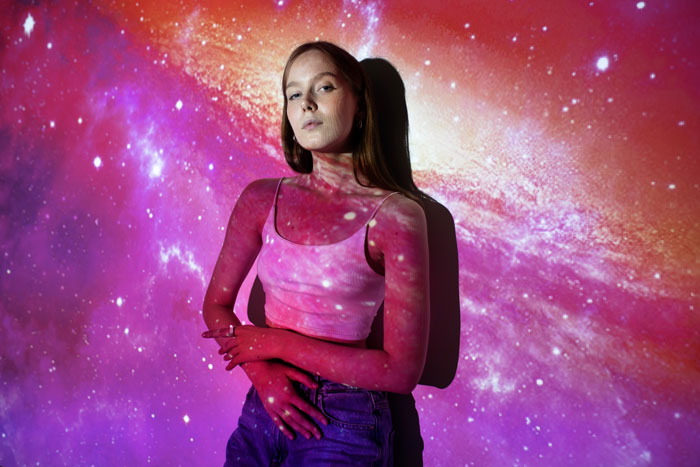A woman with a galaxy projected onto her, representing nebulasexual identity within the LGBT community. A woman with a galaxy projected onto her, representing nebulasexual identity within the LGBT community.