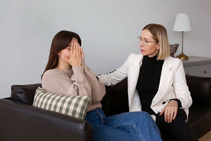 A therapist comforting a crying woman, discussing feelings and what nebulasexual means for LGBT individuals. A therapist comforting a crying woman, discussing feelings and what nebulasexual means for LGBT individuals.