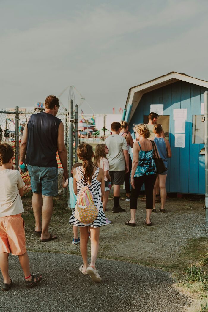 A group of people waiting in line outside a blue shack. Hilarious micro feminism clap backs.