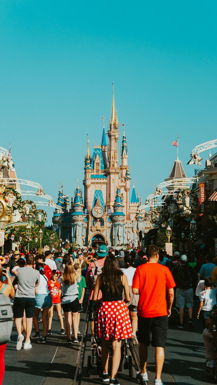 Crowds of people at a theme park, a setting where one might witness disturbing public incidents.
