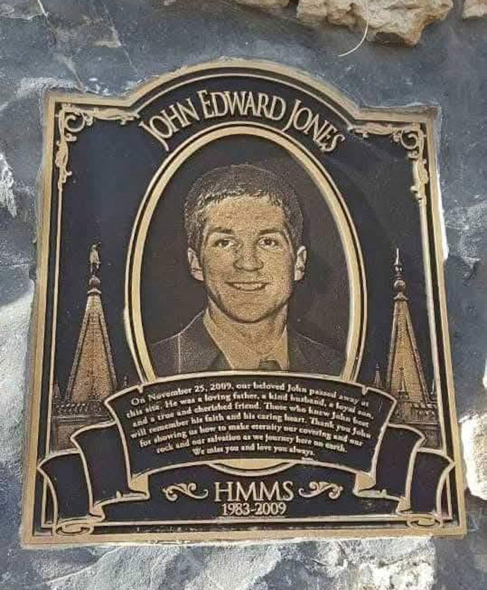 A commemorative plaque with a photo of John Edward Jones, the man trapped headfirst in Nutty Putty Cave.