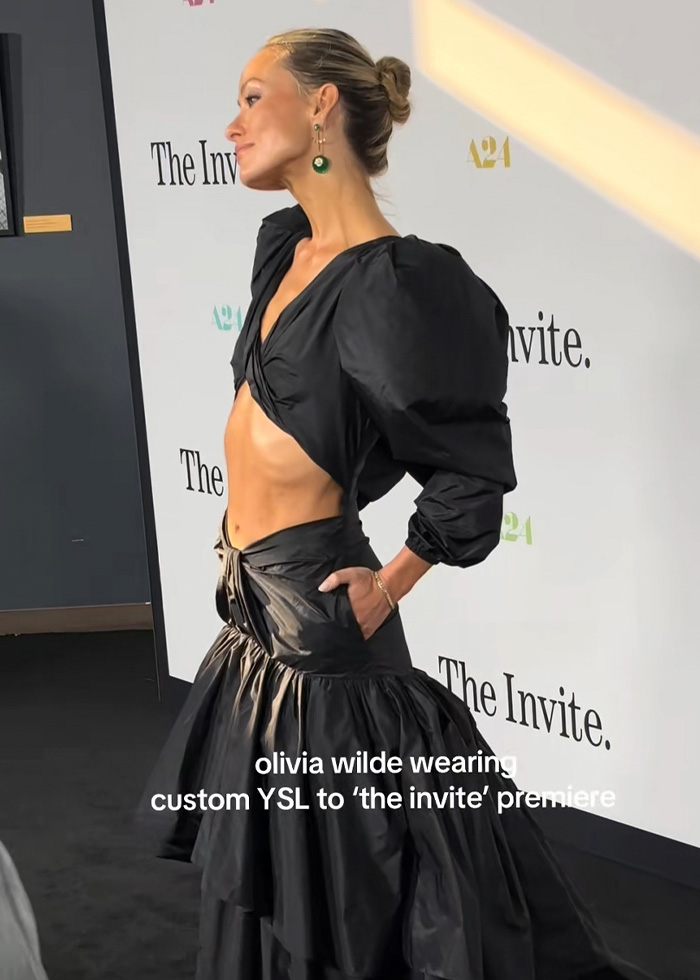 Side view of Olivia Wilde at The Invite premiere, showcasing her dramatically slimmer frame in a custom YSL gown. Side view of Olivia Wilde at The Invite premiere, showcasing her dramatically slimmer frame in a custom YSL gown.