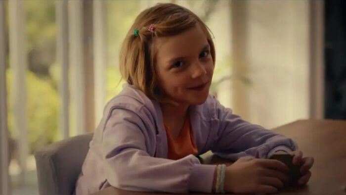 A young girl with blonde hair and a lavender hoodie smiles sweetly, from The Odyssey trailer. A young girl with blonde hair and a lavender hoodie smiles sweetly, from The Odyssey trailer.
