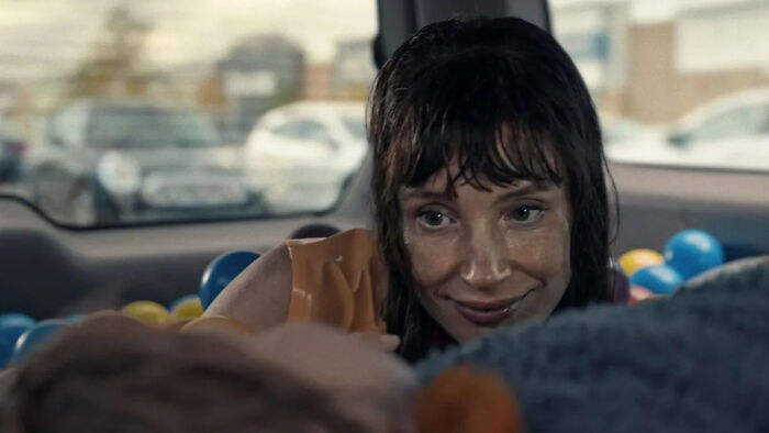 A woman with wet hair smiles from the backseat of a car filled with colorful balls, for The Odyssey trailer. A woman with wet hair smiles from the backseat of a car filled with colorful balls, for The Odyssey trailer.