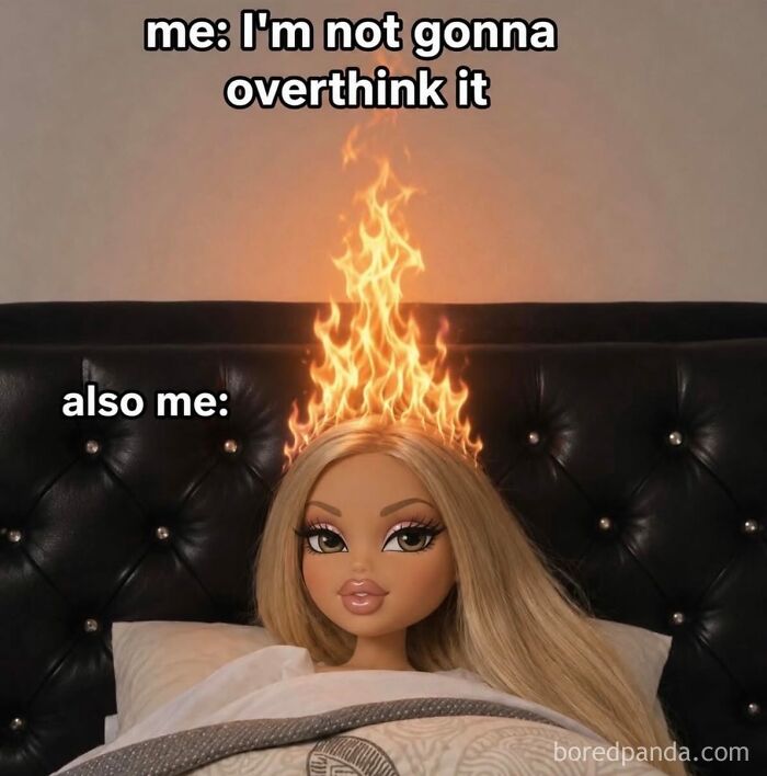 A hilarious meme of a doll in bed with flames on her head, representing overthinking.