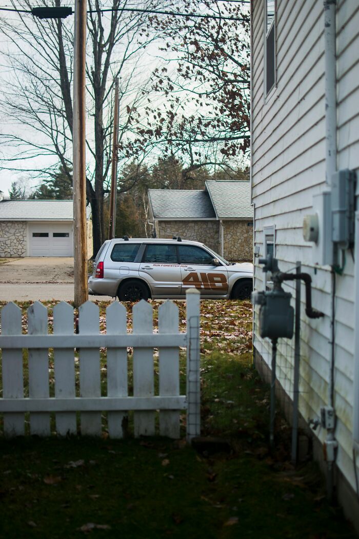 A silver SUV parked on a suburban street, illustrating unexpected twists and turns in daily life.