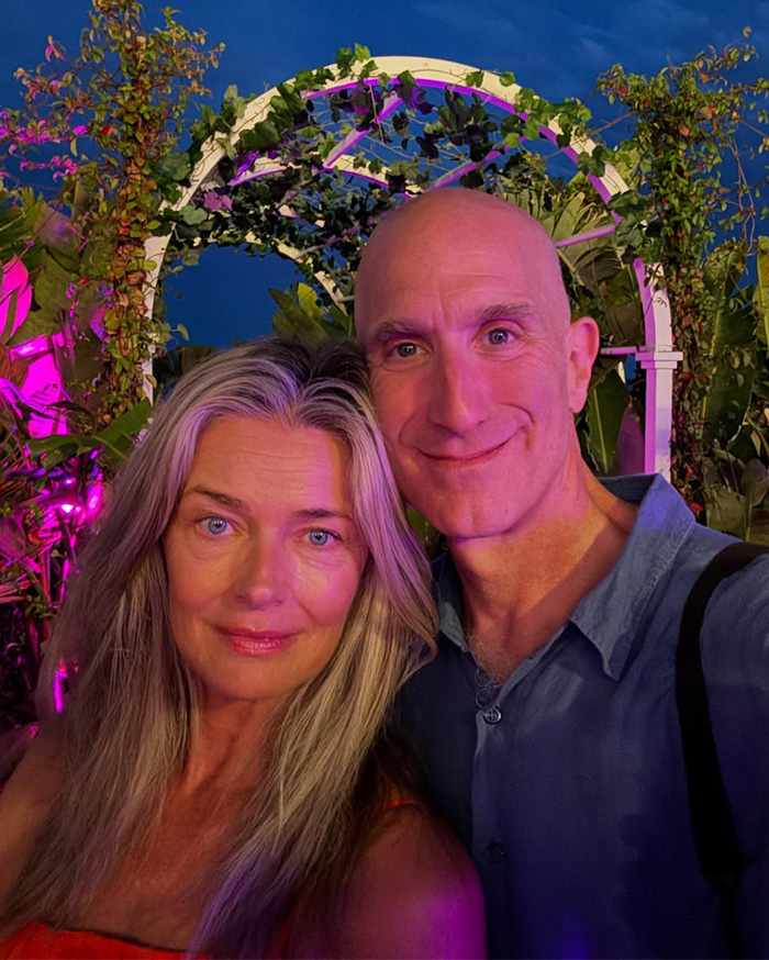 Model and her husband smiling outdoors at night, wedding photos went viral as many praise how she aged.