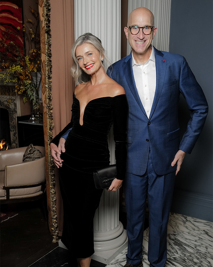 Model and her husband posing at an event. Her wedding photos went viral as many praise how she aged.