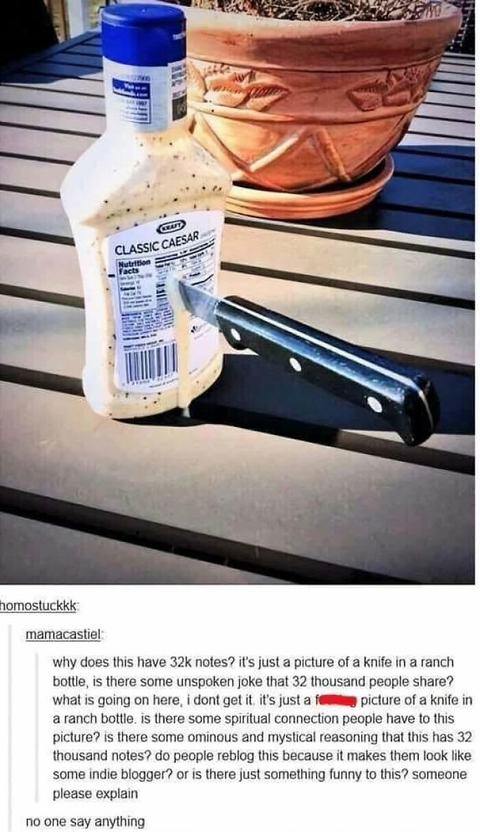 A bottle of Classic Caesar dressing with a knife stuck into it, prompting comments correcting someone online about the image's meaning.