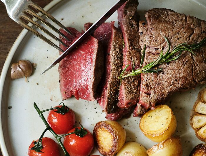 A perfectly cooked steak with roasted vegetables, a culinary delight for those with a vengeful spirit.