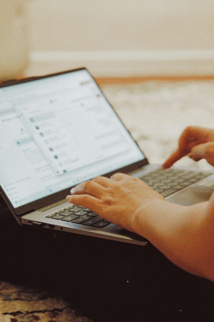 Hands typing on a laptop, uncovering behind the scenes secrets companies really don't want you to know.