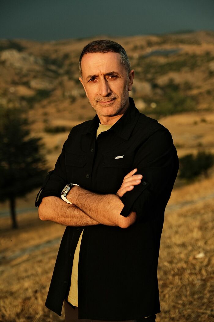 A man with arms crossed in an outdoor setting, embodying the spirit of stereotypically white phrases.