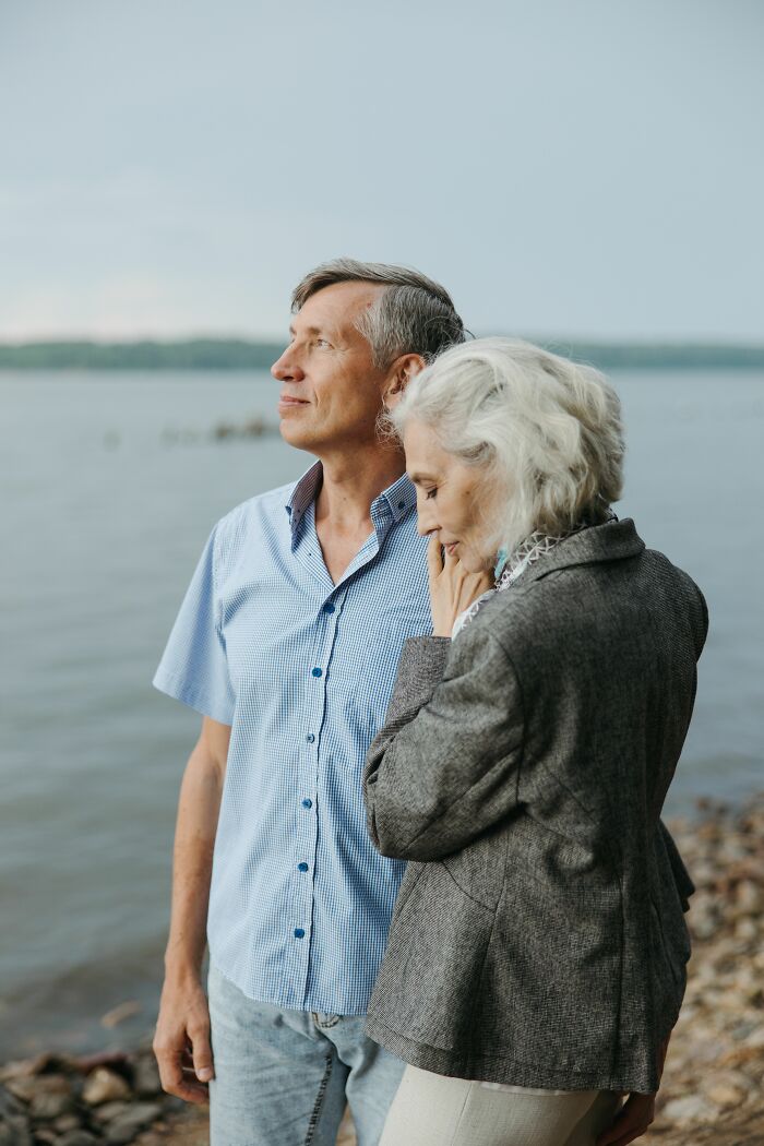 An older couple looking out over water, contemplating things everyone should know before getting married.