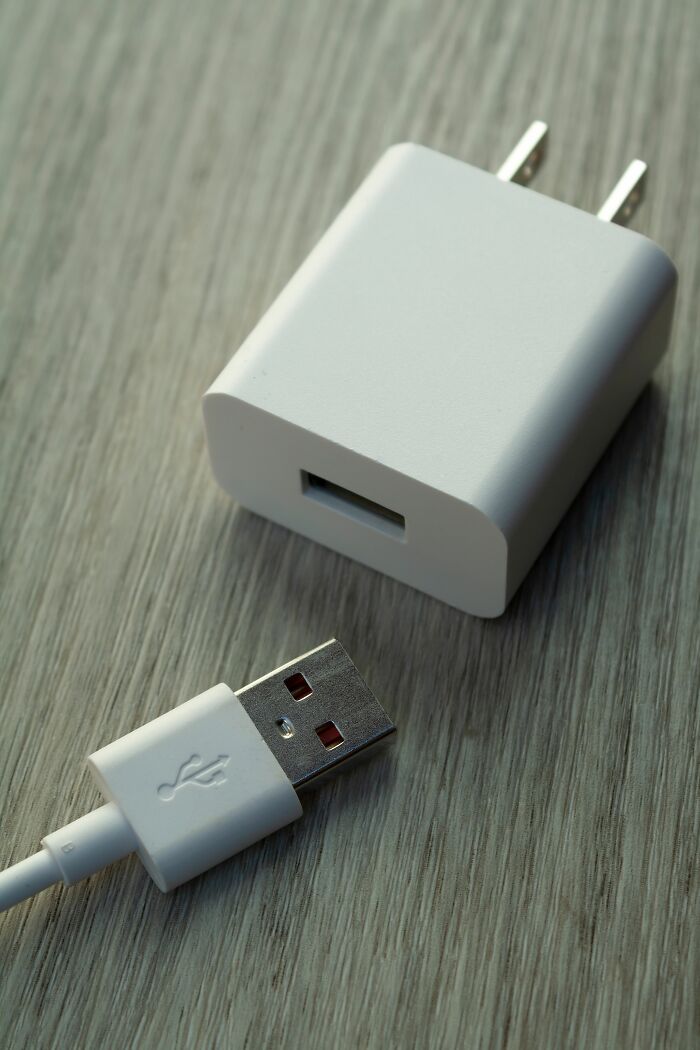 A white USB charger and cable, a cheating red flag suggesting hidden device usage.