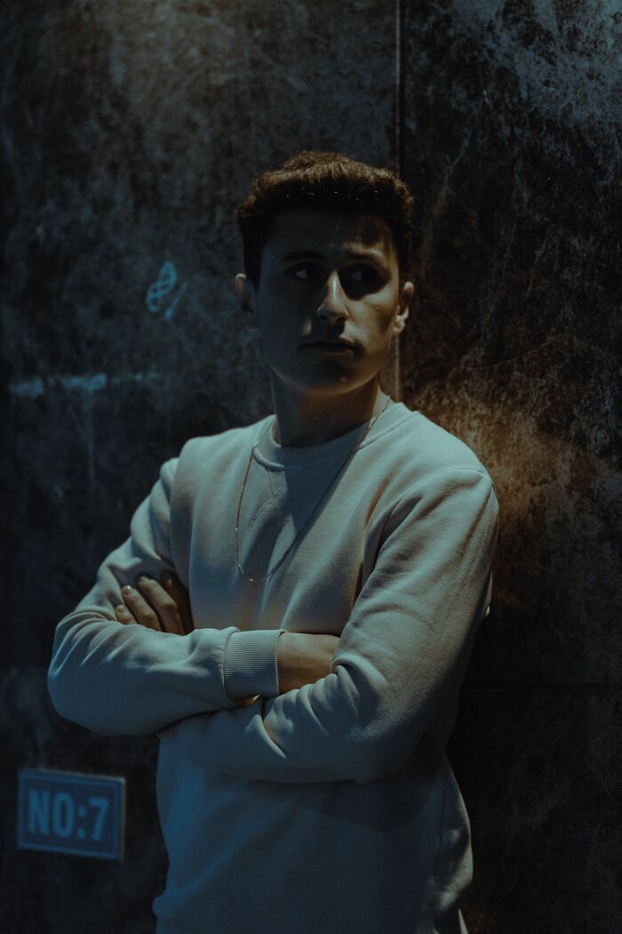 A young man looking away, conveying a feeling of needing to get away from creeps.