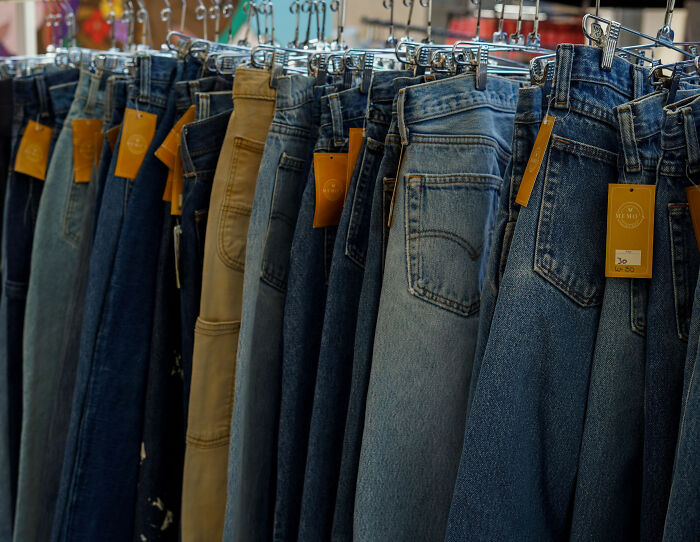 A rack of various jeans for sale, highlighting clothing selection challenges faced by a plus-size influencer. A rack of various jeans for sale, highlighting clothing selection challenges faced by a plus-size influencer.